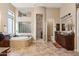 Bright and spacious main bathroom featuring a soaking tub, dual sinks, and a walk-in shower at 3529 N Boulder Canyon St, Mesa, AZ 85207