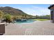 Backyard pool with putting green and desert landscape at 3529 N Boulder Canyon St, Mesa, AZ 85207