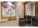 Stylish powder room features a glass bowl sink, black marble countertop, and unique, colorful artwork at 3529 N Boulder Canyon St, Mesa, AZ 85207