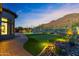 Expansive backyard featuring putting green, pool, and mountain views at 3529 N Boulder Canyon St, Mesa, AZ 85207