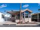 Attractive home exterior boasting a covered porch, manicured garden, and large windows at 359 Felspar Dr, Apache Junction, AZ 85119
