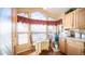 Kitchen dining area features a breakfast nook with a bright window and matching wood cabinetry at 359 Felspar Dr, Apache Junction, AZ 85119