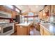 Well-lit kitchen featuring wood cabinets, stainless steel appliances, and a cozy dining nook with great natural light at 359 Felspar Dr, Apache Junction, AZ 85119