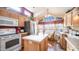 Well-lit kitchen featuring wood cabinets, stainless steel appliances, and a cozy dining nook with great natural light at 359 Felspar Dr, Apache Junction, AZ 85119