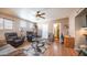 Bright and airy living room featuring hardwood floors, cozy seating, and ample natural light at 359 Felspar Dr, Apache Junction, AZ 85119