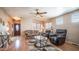 Inviting living room features a ceiling fan, windows with blinds, wood laminate flooring and comfortable seating at 359 Felspar Dr, Apache Junction, AZ 85119