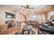 Cozy living room with a fireplace, ceiling fan, and plentiful seating space at 359 Felspar Dr, Apache Junction, AZ 85119