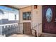 Cozy covered porch with seating and a view, next to a decorative front door at 359 Felspar Dr, Apache Junction, AZ 85119