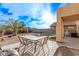 Charming backyard patio with an outdoor dining area, perfect for entertaining or relaxing at 36469 W Alhambra St, Maricopa, AZ 85138