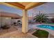 Inviting backyard with a refreshing pool, patio, and a putting green for outdoor enjoyment at 36469 W Alhambra St, Maricopa, AZ 85138