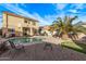 Serene backyard oasis featuring a pool, lush landscaping, and a patio for outdoor relaxation at 36469 W Alhambra St, Maricopa, AZ 85138