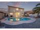 Private backyard with a sparkling pool, lush landscaping, and an outdoor dining area at 36469 W Alhambra St, Maricopa, AZ 85138