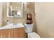 Compact bathroom featuring a vanity with a sink, a mirror and a toilet at 36469 W Alhambra St, Maricopa, AZ 85138