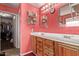 Bathroom with double sinks, wood cabinets and shelves for storage at 36469 W Alhambra St, Maricopa, AZ 85138