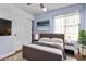 Relaxing bedroom featuring a cozy bed, soft lighting, and a view of an abstract art piece at 36469 W Alhambra St, Maricopa, AZ 85138