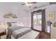 Stylized bedroom offering a cozy rug, a ceiling fan, window with natural light and decorative shelving at 36469 W Alhambra St, Maricopa, AZ 85138