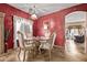Elegant dining room with a glass table, ornate chairs and abundant natural light at 36469 W Alhambra St, Maricopa, AZ 85138