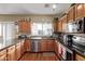Well-lit kitchen with custom wood cabinets, stainless steel appliances, and granite countertops at 36469 W Alhambra St, Maricopa, AZ 85138