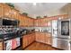 Well-lit kitchen with custom wood cabinets, stainless steel appliances, and granite countertops at 36469 W Alhambra St, Maricopa, AZ 85138
