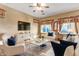 Bright living room featuring a large TV, modern furnishings, and stylish decor at 36469 W Alhambra St, Maricopa, AZ 85138