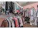 Spacious walk-in closet providing ample storage with double hanging rods, and shelving to accommodate an extensive wardrobe at 36469 W Alhambra St, Maricopa, AZ 85138