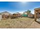 Large backyard with gazebo, shed, and lush palm trees, perfect for relaxation at 38085 W San Capistrano Ave, Maricopa, AZ 85138