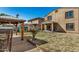 The backyard is complete with a covered gazebo sitting area, shed, and grassy areas at 38085 W San Capistrano Ave, Maricopa, AZ 85138