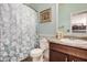 Charming bathroom with a shower, vanity, and decorative floral accents at 38085 W San Capistrano Ave, Maricopa, AZ 85138