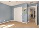 Cozy bedroom with neutral carpet, closet, and access to adjacent room at 38085 W San Capistrano Ave, Maricopa, AZ 85138