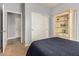 Bedroom with neutral walls, carpet floors, closet, and built-in shelving unit at 38085 W San Capistrano Ave, Maricopa, AZ 85138