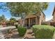 Two-story home featuring desert landscaping, a charming front porch and an attached two-car garage at 38085 W San Capistrano Ave, Maricopa, AZ 85138