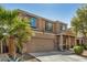 Two-story home features a large front yard, desert landscaping, attached two-car garage, and covered porch at 38085 W San Capistrano Ave, Maricopa, AZ 85138