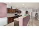 Kitchen showcases dark wood cabinets, stainless steel appliances, stone countertops and tile backsplash at 38085 W San Capistrano Ave, Maricopa, AZ 85138