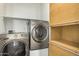 Convenient laundry room features modern washer and dryer, plus added storage at 38085 W San Capistrano Ave, Maricopa, AZ 85138