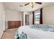 Bright primary bedroom featuring a ceiling fan, closet, and dresser at 38085 W San Capistrano Ave, Maricopa, AZ 85138