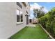 Backyard with artificial grass, pavers and a porch swing at 4216 N 27Th St # 108, Phoenix, AZ 85016
