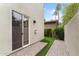 Backyard patio area leading to the house with artificial grass and privacy wall at 4216 N 27Th St # 108, Phoenix, AZ 85016