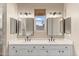 Primary bathroom featuring dual sinks, large mirrors, vanity lighting and an abundance of cabinet space at 4216 N 27Th St # 108, Phoenix, AZ 85016