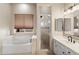 Bright bathroom featuring a tub under the window and a separate shower with a glass door at 4216 N 27Th St # 108, Phoenix, AZ 85016