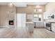 Living area boasts a fireplace, an open-concept layout, and a kitchen with white cabinetry and stone countertops at 4216 N 27Th St # 108, Phoenix, AZ 85016