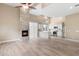 Bright, open living area featuring fireplace, wood floors, and a modern kitchen with stainless steel appliances at 4216 N 27Th St # 108, Phoenix, AZ 85016