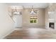 Spacious living room featuring wood floors, a fireplace, and natural light coming in through large windows at 4216 N 27Th St # 108, Phoenix, AZ 85016