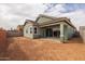 View of backyard with fresh dirt, with a green house and a block fence for privacy at 4265 E John St, Gilbert, AZ 85295