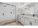 Bright bathroom featuring a glass enclosed shower, double sink vanity, and white cabinets at 4265 E John St, Gilbert, AZ 85295