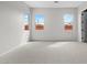 Bright bedroom with three windows, neutral carpet, and fresh paint at 4265 E John St, Gilbert, AZ 85295
