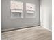 Bright, empty room with wood-look floors and two windows, ready to be personalized at 4265 E John St, Gilbert, AZ 85295