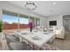 Elegant dining setup with marble table, comfortable seating, and views of backyard at 4265 E John St, Gilbert, AZ 85295