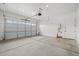 A garage with an automatic door, with a water heater near the service door at 4265 E John St, Gilbert, AZ 85295