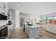 Bright open kitchen showcasing granite counters, white cabinets, stainless appliances, dining area and island seating at 4265 E John St, Gilbert, AZ 85295
