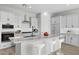 Modern kitchen with granite countertops, white cabinetry, stainless steel appliances, and eat in kitchen island at 4265 E John St, Gilbert, AZ 85295